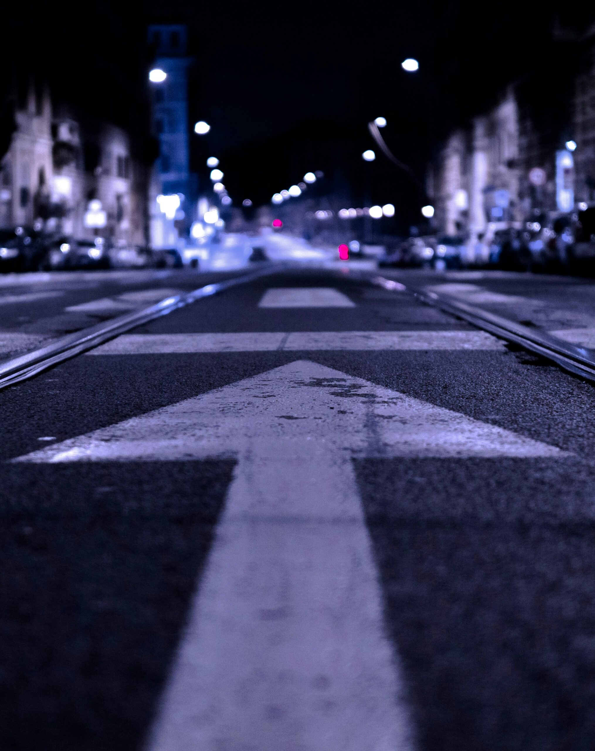 Ein beleuchteter Straßenpfeil zeigt bei Nacht den Weg in Richtung erfolgreicher App Store Optimierung.